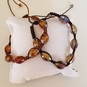 Two fashion bracelets with iridescent finish and faceted crystals.